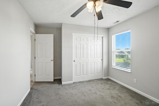 8939 Perry Ave, Franklin, OH 45005 - unfurnished bedroom with a textured ceiling, carpet, a closet, and ceiling fan