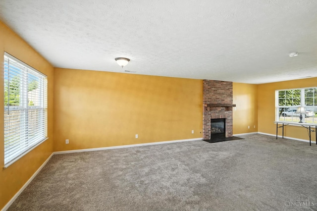 8939 Perry Ave, Franklin, OH 45005 - unfurnished living room featuring carpet floors, a textured ceiling, and a fireplace