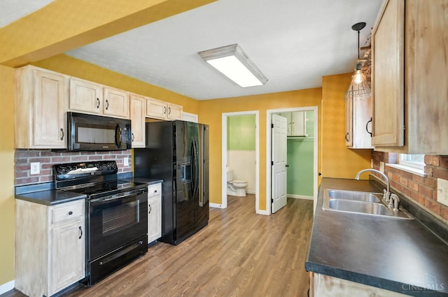 8939 Perry Ave, Franklin, OH 45005 - kitchen with black appliances, dark countertops, wood finished floors, and decorative backsplash