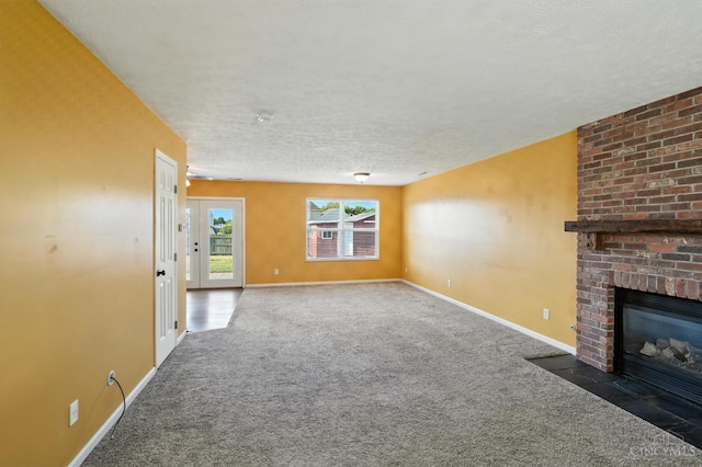 8939 Perry Ave, Franklin, OH 45005 - unfurnished living room featuring carpet floors, a brick fireplace, and a textured ceiling