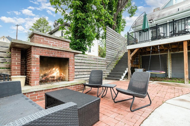 1117 Cypress St, Cincinnati, OH 45206 - view of patio featuring an outdoor brick fireplace and stairway