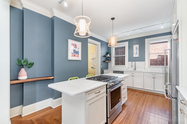 1117 Cypress St, Cincinnati, OH 45206 - kitchen with stainless steel appliances, rail lighting, ornamental molding, white cabinetry, and decorative backsplash