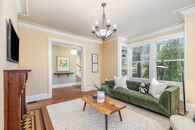 1117 Cypress St, Cincinnati, OH 45206 - living area with wood finished floors, a chandelier, crown molding, and built in features