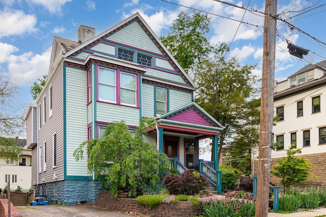 1117 Cypress St, Cincinnati, OH 45206 - victorian house with a porch and a chimney