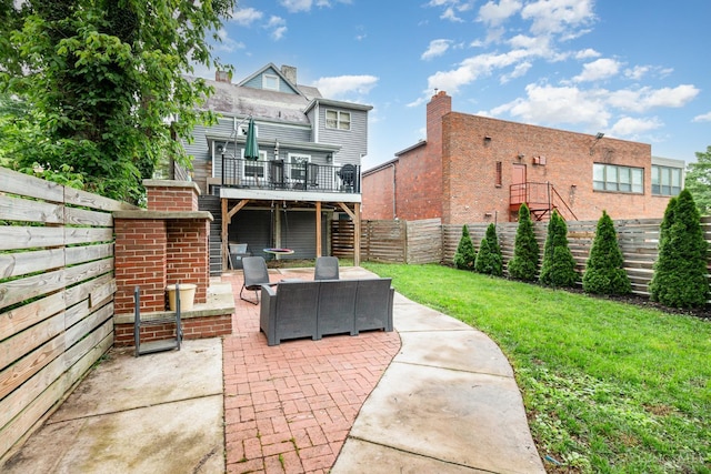 1117 Cypress St, Cincinnati, OH 45206 - fenced backyard featuring a patio, a wooden deck, and an outdoor living space