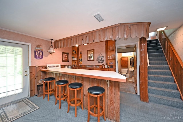 7423 View Place Dr, Springfield Twp, OH 45224 - indoor bar featuring dark colored carpet, stairs, and pendant lighting