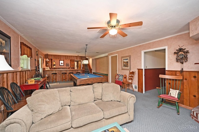 7423 View Place Dr, Springfield Twp, OH 45224 - living area with billiards, carpet flooring, wood walls, ceiling fan, and a wainscoted wall