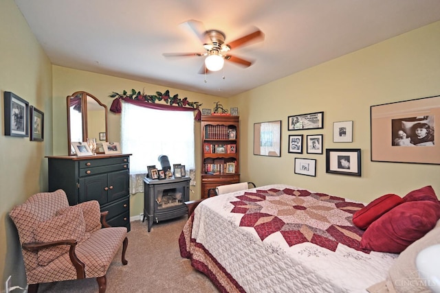7423 View Place Dr, Springfield Twp, OH 45224 - bedroom featuring a wood stove, light carpet, and ceiling fan