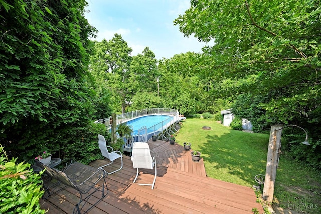 7423 View Place Dr, Springfield Twp, OH 45224 - wooden deck with an outdoor pool, a lawn, and a shed