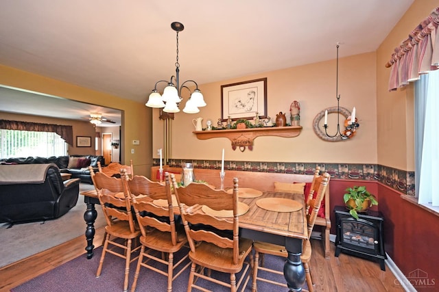 7423 View Place Dr, Springfield Twp, OH 45224 - dining space with a chandelier, wood finished floors, and a wood stove