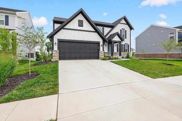 5322 Observer Ct, Turtle Creek Twp, OH 45036 - view of front of house featuring board and batten siding, concrete driveway, a front yard, and stone siding