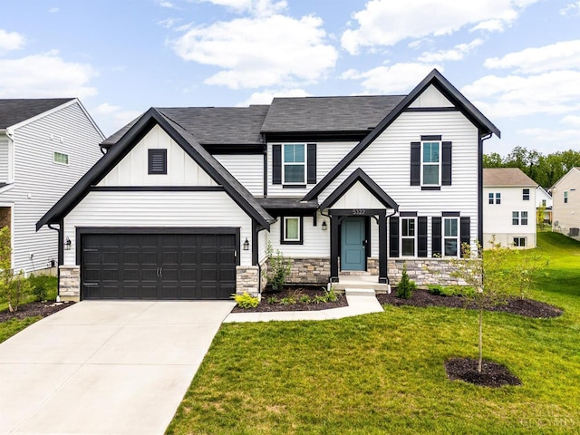 5322 Observer Ct, Turtle Creek Twp, OH 45036 - view of front of home featuring board and batten siding, stone siding, a front yard, driveway, and roof with shingles