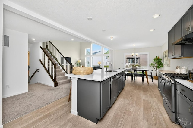 5322 Observer Ct, Turtle Creek Twp, OH 45036 - kitchen featuring stainless steel appliances, light countertops, light wood finished floors, a kitchen island with sink, and recessed lighting