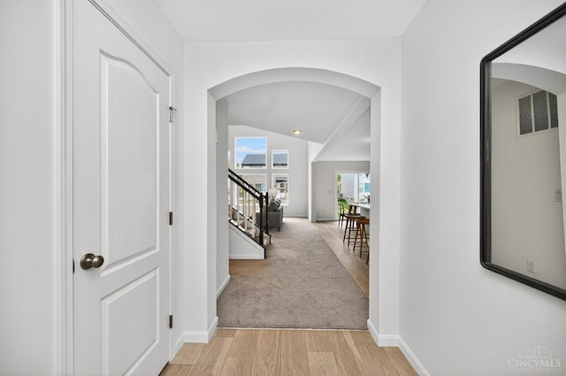 5322 Observer Ct, Turtle Creek Twp, OH 45036 - corridor featuring arched walkways, stairway, and light wood-style floors