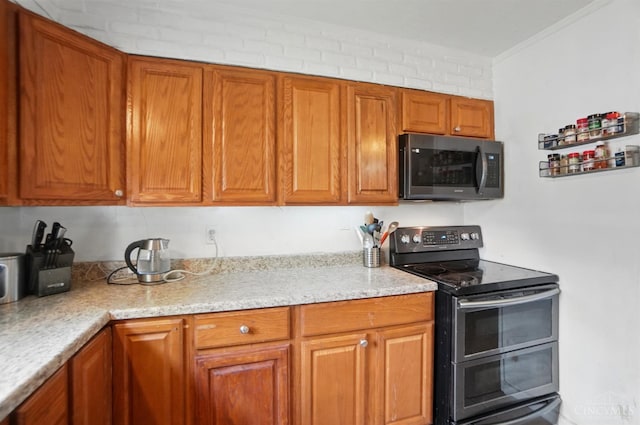 1643 Biscayne Dr, Saint Clair Twp, OH 45013 - kitchen with double oven range, brown cabinets, and crown molding