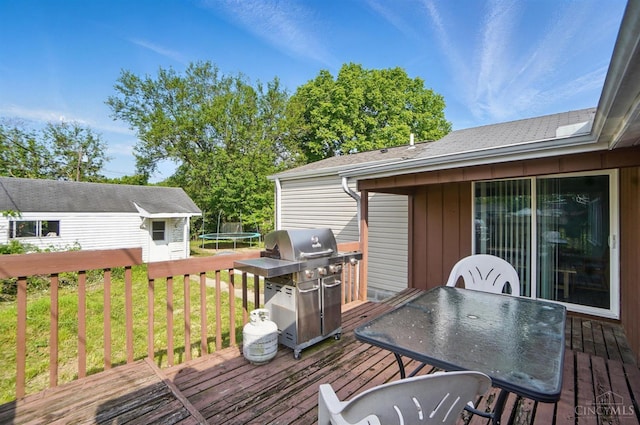 1643 Biscayne Dr, Saint Clair Twp, OH 45013 - wooden deck featuring a trampoline, grilling area, a lawn, a storage shed, and outdoor dining space