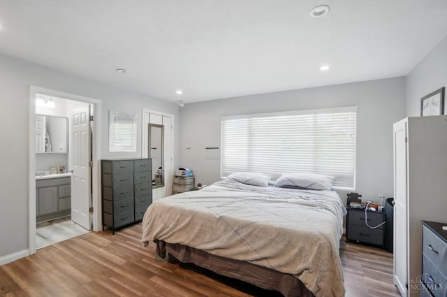 1643 Biscayne Dr, Saint Clair Twp, OH 45013 - bedroom with wood finished floors, recessed lighting, and connected bathroom