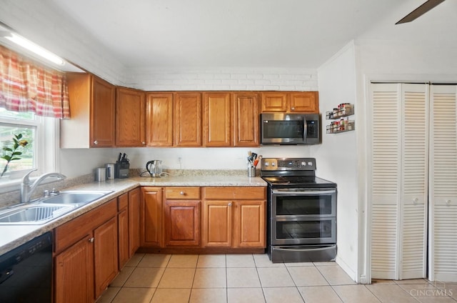 1643 Biscayne Dr, Saint Clair Twp, OH 45013 - kitchen featuring stainless steel appliances, brown cabinets, light countertops, and light tile patterned floors