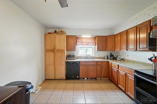 1643 Biscayne Dr, Saint Clair Twp, OH 45013 - kitchen featuring black appliances, light countertops, light tile patterned flooring, and brown cabinetry