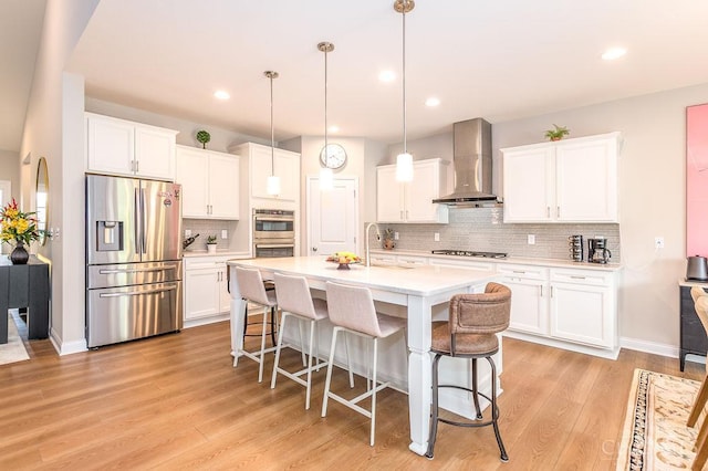 9302 W Meadow Dr, West Chester, OH 45069 - kitchen with stainless steel appliances, wall chimney range hood, tasteful backsplash, white cabinetry, and recessed lighting