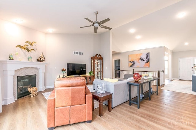 9302 W Meadow Dr, West Chester, OH 45069 - living area with lofted ceiling, a ceiling fan, light wood finished floors, and a fireplace