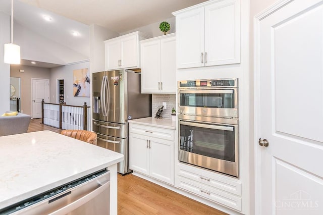 9302 W Meadow Dr, West Chester, OH 45069 - kitchen featuring appliances with stainless steel finishes, light wood-style floors, white cabinetry, tasteful backsplash, and light countertops