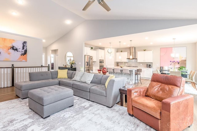 9302 W Meadow Dr, West Chester, OH 45069 - living area featuring light wood-type flooring, a ceiling fan, high vaulted ceiling, recessed lighting, and a chandelier