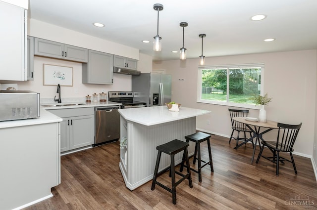 601 Comet Dr, Union Twp, OH 45244 - kitchen featuring stainless steel appliances, under cabinet range hood, light countertops, dark wood-type flooring, and recessed lighting