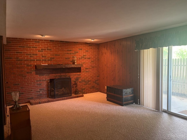 44 Strathmore Blvd, Athens, OH 45701 - unfurnished living room featuring carpet floors, a brick fireplace, and wooden walls