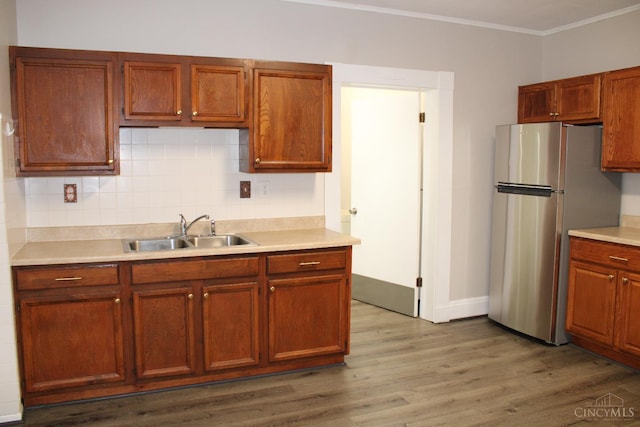 1841 Carll St, Cincinnati, OH 45225 - kitchen with freestanding refrigerator, crown molding, light countertops, and wood finished floors