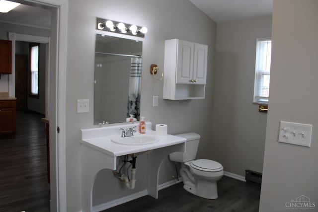 1841 Carll St, Cincinnati, OH 45225 - bathroom with wood finished floors, a baseboard heating unit, and a shower with shower curtain
