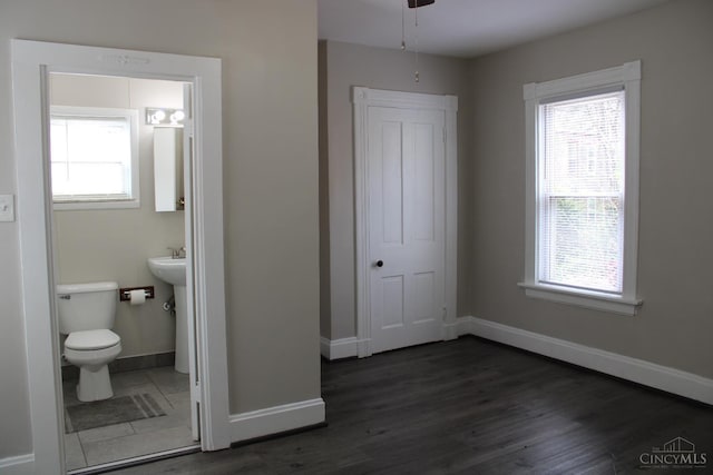 1841 Carll St, Cincinnati, OH 45225 - unfurnished bedroom featuring dark wood-type flooring, connected bathroom, and a closet