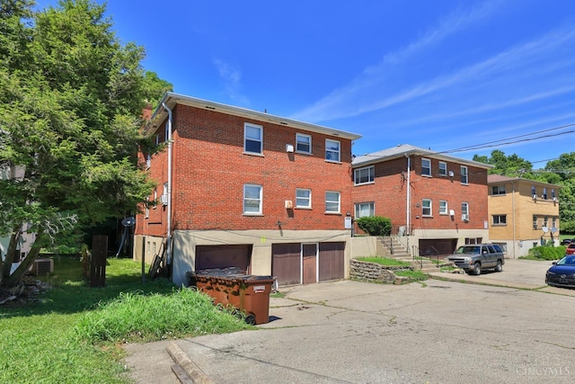 4404 W 8th St, Cincinnati, OH 45238 - view of property with a garage, driveway, and stairs