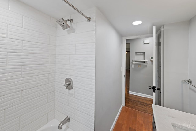 5611 Glengate Ln, Cincinnati, OH 45212 - bathroom featuring wood finished floors and bathtub / shower combination