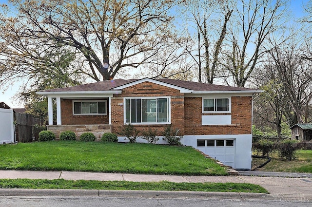 5611 Glengate Ln, Cincinnati, OH 45212 - view of front of house featuring an attached garage, brick siding, and driveway