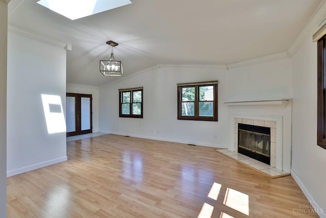 115 Treeline Ct, Harrison, OH 45030 - unfurnished living room featuring ornamental molding, light wood-type flooring, a chandelier, a tile fireplace, and lofted ceiling
