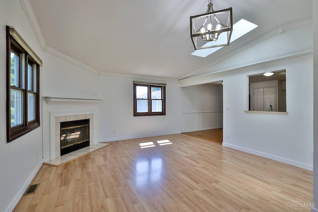 115 Treeline Ct, Harrison, OH 45030 - unfurnished living room with ornamental molding, vaulted ceiling, light wood-style flooring, a fireplace, and a chandelier