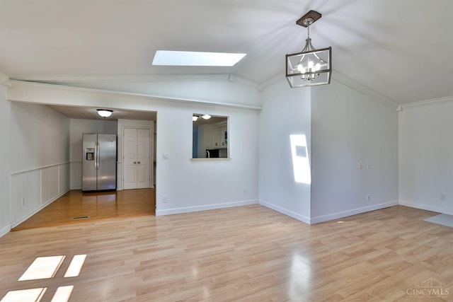 115 Treeline Ct, Harrison, OH 45030 - spare room with a skylight, lofted ceiling, a chandelier, light wood-style flooring, and ornamental molding