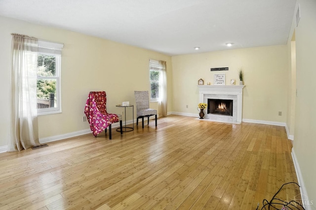 4653 Cardinal Dr, Union Twp, OH 45244 - sitting room featuring healthy amount of natural light, light wood-type flooring, and a fireplace with flush hearth