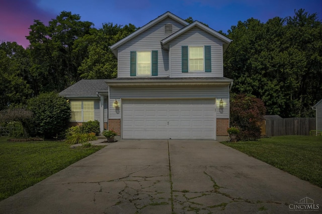 4653 Cardinal Dr, Union Twp, OH 45244 - traditional-style home featuring brick siding, an attached garage, and concrete driveway