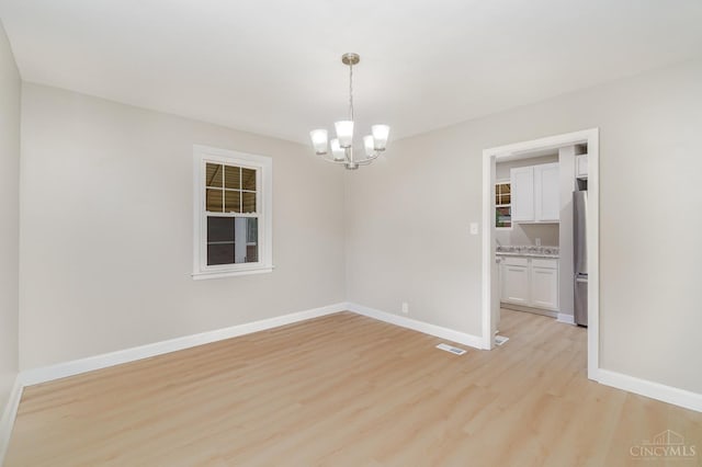 1427 Beaverton Ave, Cincinnati, OH 45237 - empty room featuring light wood-style floors and a chandelier