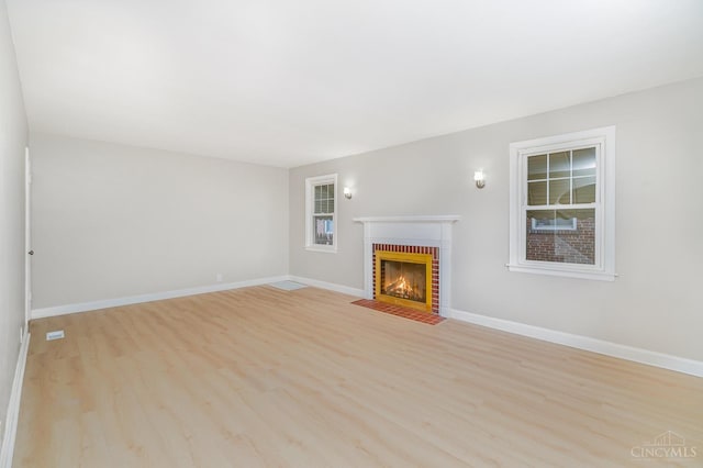 1427 Beaverton Ave, Cincinnati, OH 45237 - unfurnished living room featuring a fireplace and light wood-style flooring