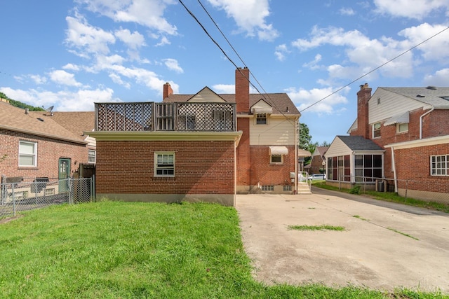 1427 Beaverton Ave, Cincinnati, OH 45237 - rear view of property featuring a chimney, brick siding, and driveway