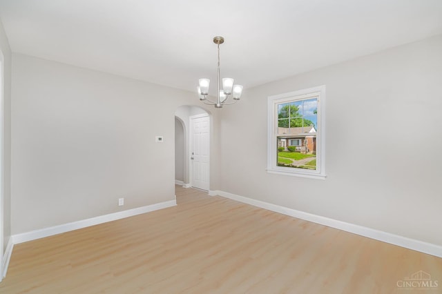 1427 Beaverton Ave, Cincinnati, OH 45237 - spare room featuring arched walkways, light wood-type flooring, and a chandelier