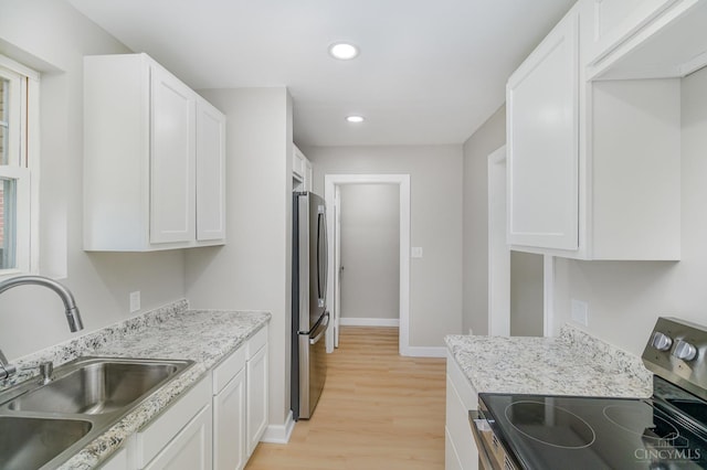 1427 Beaverton Ave, Cincinnati, OH 45237 - kitchen featuring appliances with stainless steel finishes, light wood-style flooring, white cabinetry, recessed lighting, and light stone countertops
