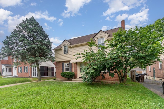 1427 Beaverton Ave, Cincinnati, OH 45237 - view of front facade featuring brick siding, a chimney, and a front yard