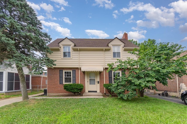 1427 Beaverton Ave, Cincinnati, OH 45237 - view of front facade featuring a chimney, brick siding, and roof with shingles