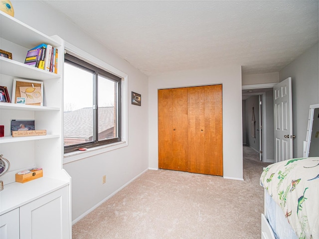 355 Grand Ave Unit 302, Cincinnati, OH 45205 - bedroom featuring light carpet, a closet, and a textured ceiling