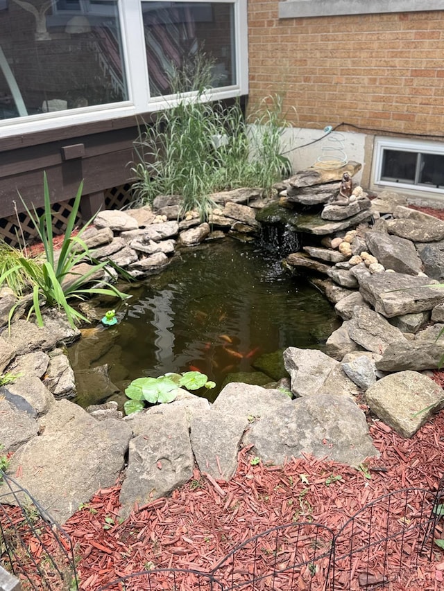 1107 Covedale Ave, Cincinnati, OH 45238 - exterior view of brick siding and a garden pond
