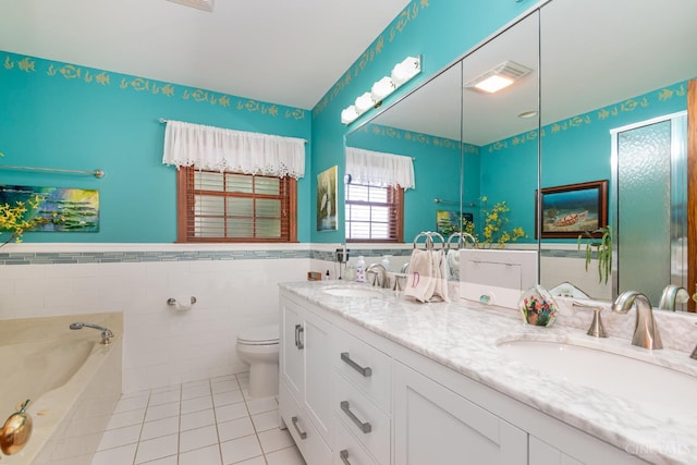 1107 Covedale Ave, Cincinnati, OH 45238 - full bathroom featuring tile patterned floors, double vanity, a bath, tile walls, and a wainscoted wall